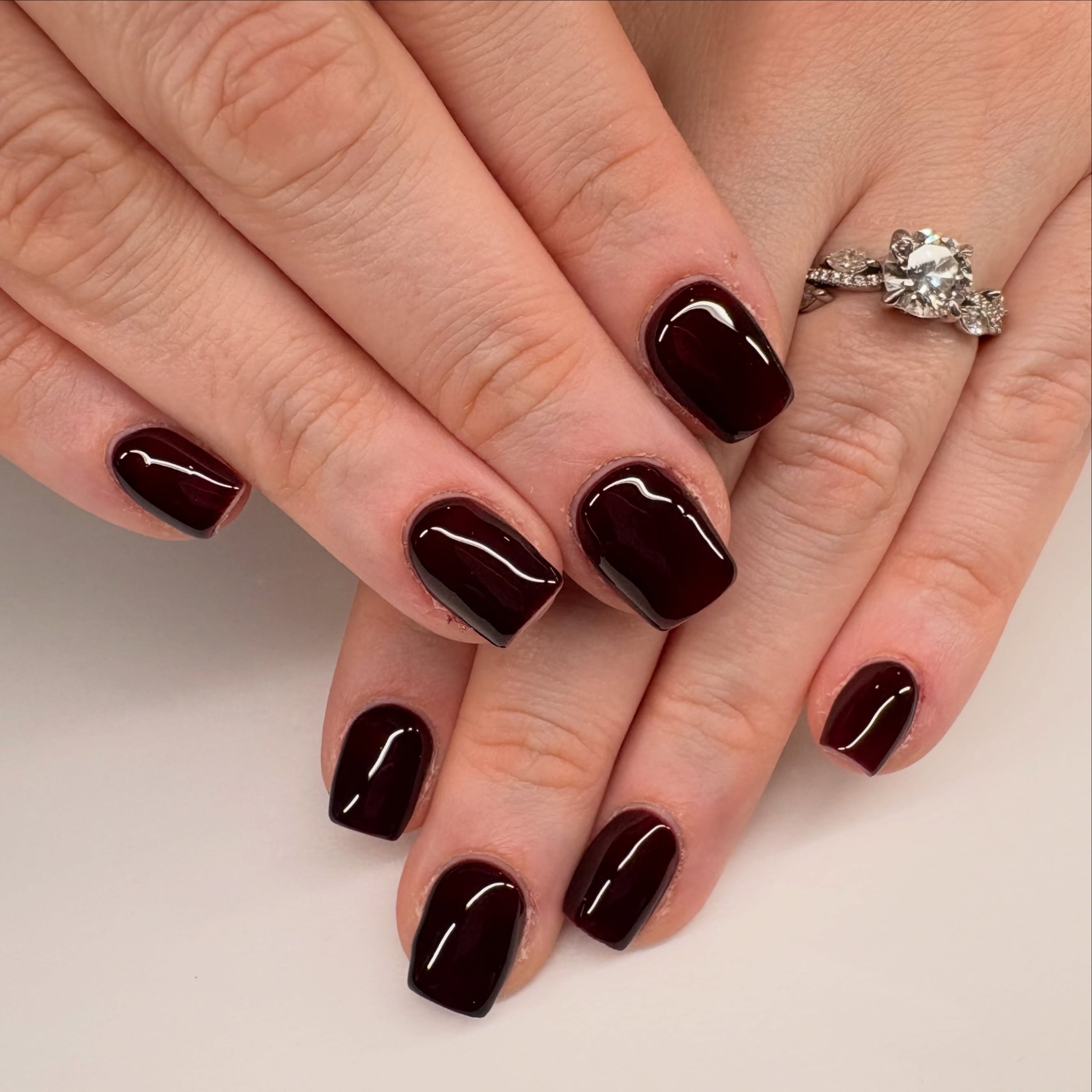 Short square nails in a deep burgundy shade